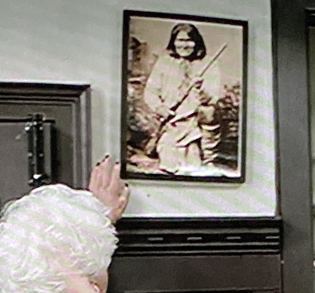 Mae straightens a photo on Ted Lasso's finale