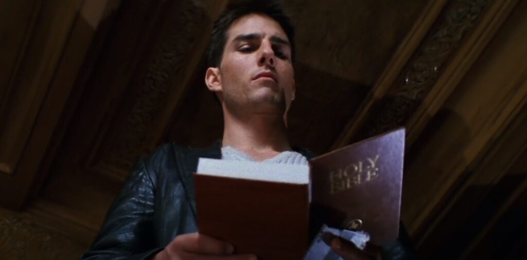 Ethan Hunt looks at a Bible in the first Mission: Impossible movie