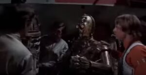 Luke and a damaged R2-D2 in Star Wars